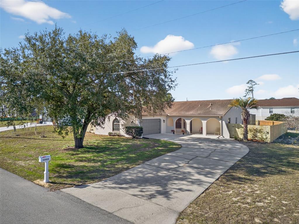 12435 Lola Drive Spring Hill, FL 34608 - Photo 4 of 63 a front view of a house with a yard