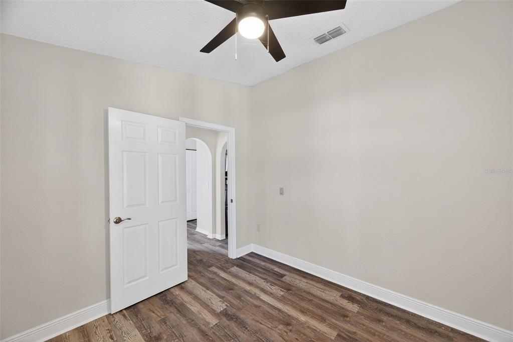 12435 Lola Drive Spring Hill, FL 34608 - Photo 41 of 63 an empty room with wooden floor