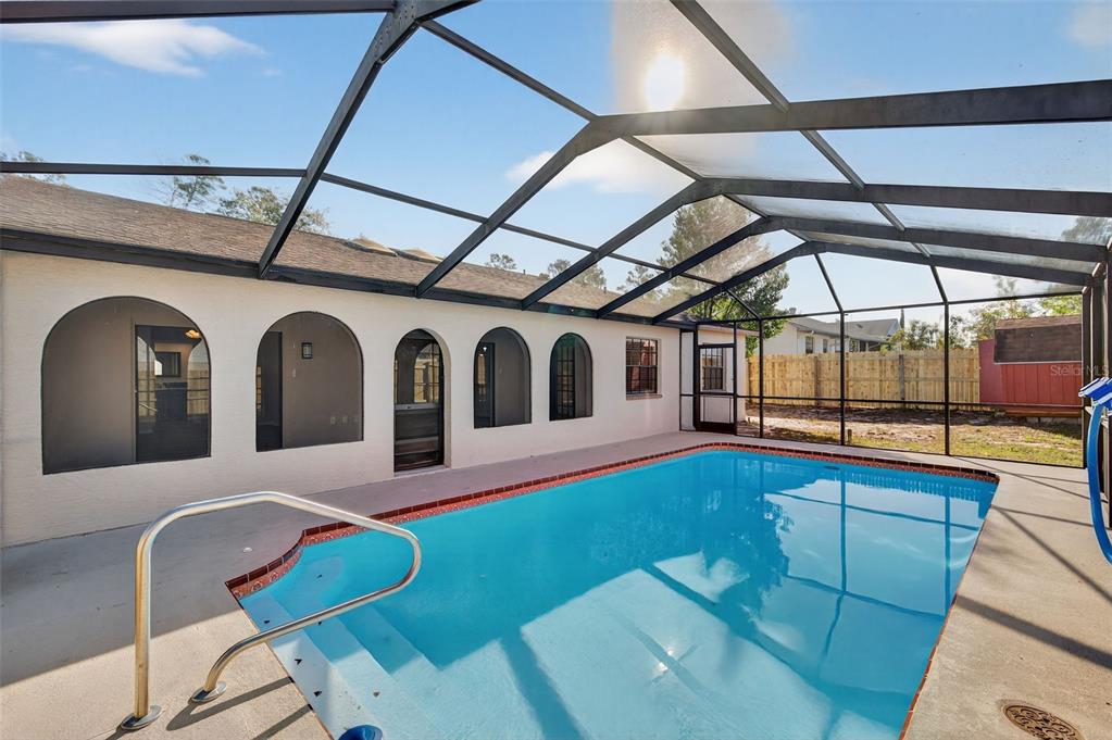 12435 Lola Drive Spring Hill, FL 34608 - Photo 50 of 63 a living room with furniture with a swimming pool