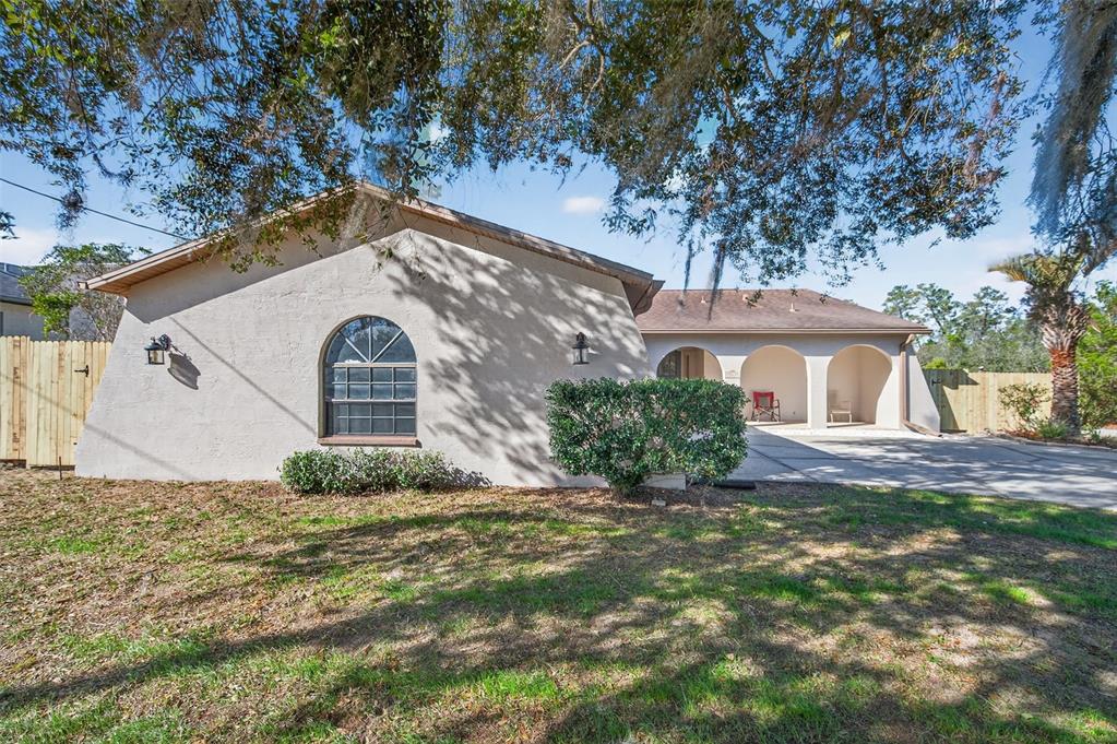 12435 Lola Drive Spring Hill, FL 34608 - Photo 6 of 63 a front view of a house with a yard