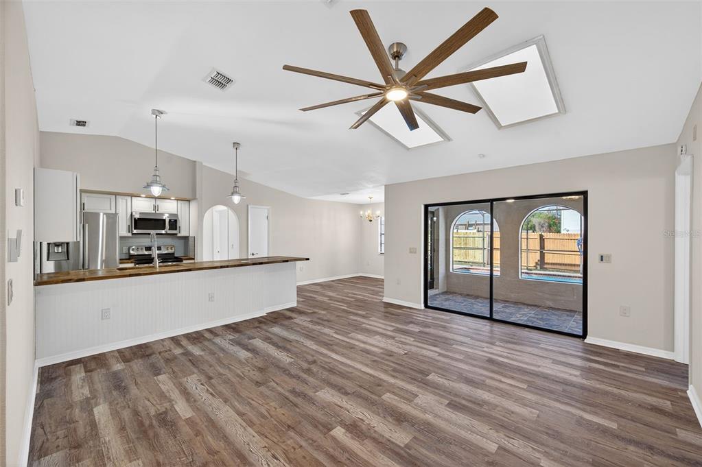 12435 Lola Drive Spring Hill, FL 34608 - Photo 9 of 63 a view of an empty room with window and wooden floor