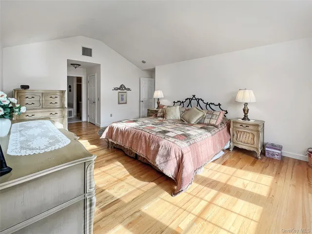 a bedroom with a bed and a dresser