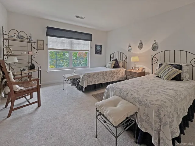 a bedroom with two beds and a large window