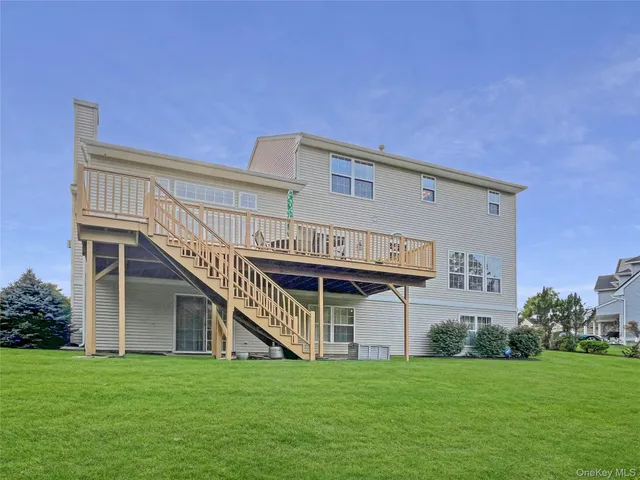 a view of a house with a big yard and large trees