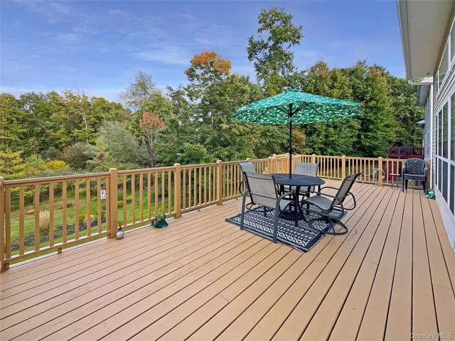 a view of a chairs on deck with wooden floor and fence