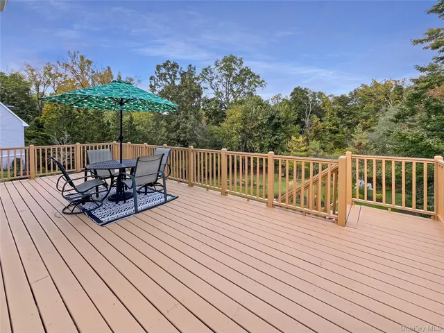 a view of balcony with seating space and trees in the background