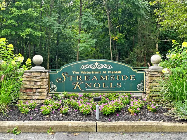 a sign that is sitting in front of flowers