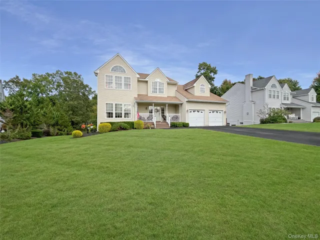 a front view of a house with a garden and yard