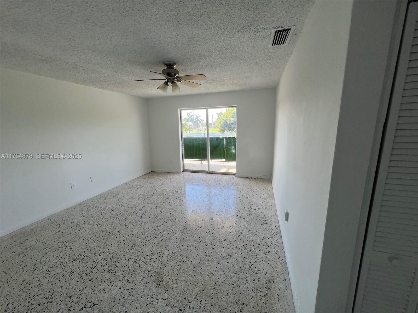 887 West 29th Street, Unit 2 Hialeah, FL 33012 - Photo 2 of 10 an empty room with windows and fan