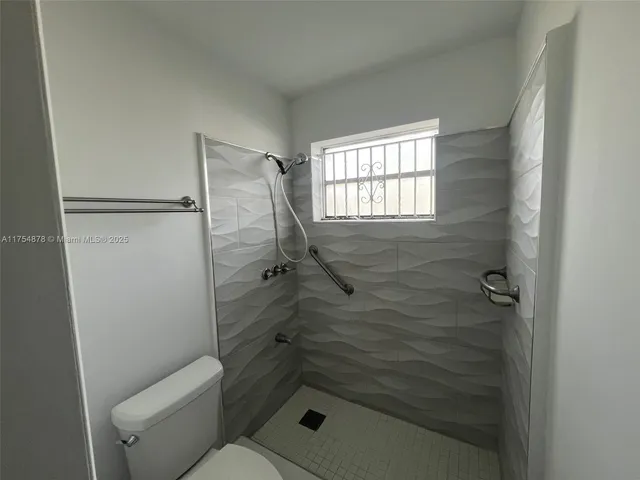 a bathroom with a shower and toilet