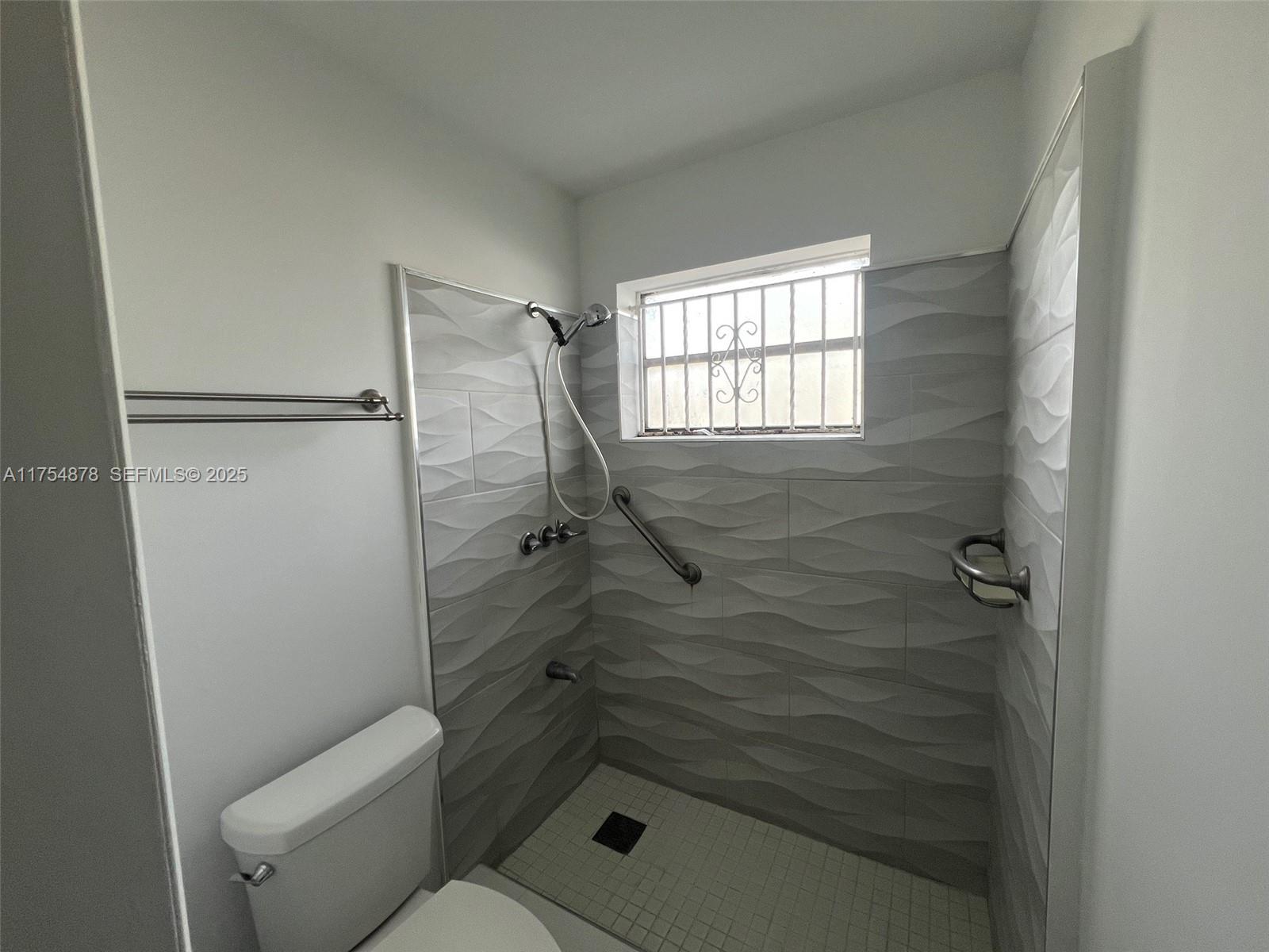 887 West 29th Street, Unit 2 Hialeah, FL 33012 - Photo 5 of 10 a bathroom with a shower and toilet