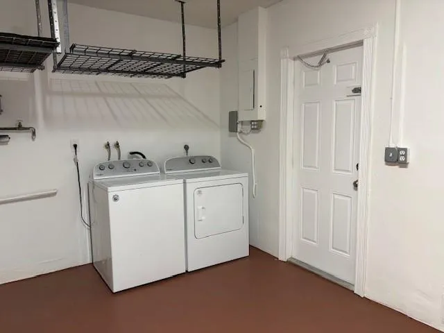 a utility room with cabinets washer and dryer