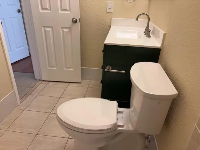 a bathroom with a sink toilet and mirror