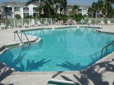 847 Tanbark Drive, Unit 101 Naples, FL 34108 - Photo 11 of 11 a view of swimming pool with outdoor seating and lake view