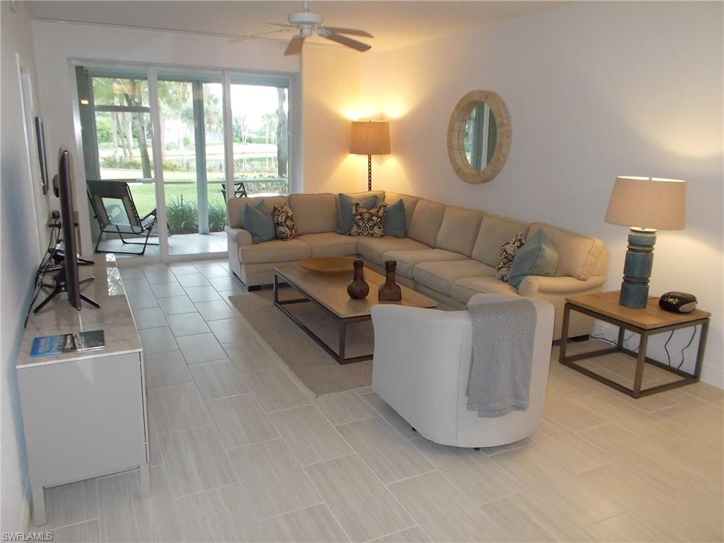 847 Tanbark Drive, Unit 101 Naples, FL 34108 - Photo 2 of 11 a living room with furniture and a large window