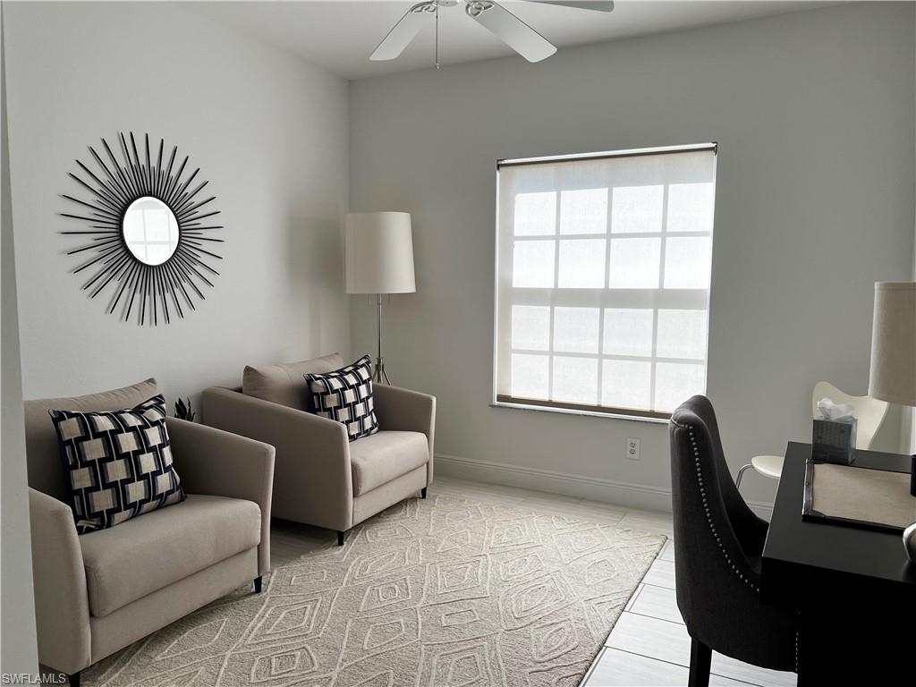 847 Tanbark Drive, Unit 101 Naples, FL 34108 - Photo 9 of 11 a living room with furniture and a large window