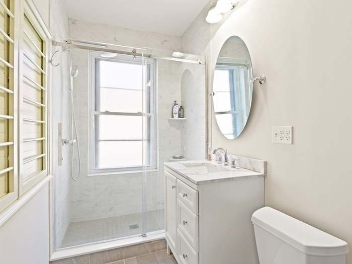 15 Strathmore Road, Unit 1 Brookline, MA 02445 - Photo 6 of 18 a bathroom with a toilet a sink and a mirror