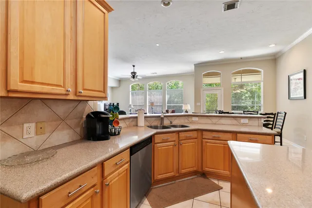 a kitchen with stainless steel appliances granite countertop a sink a stove and a microwave