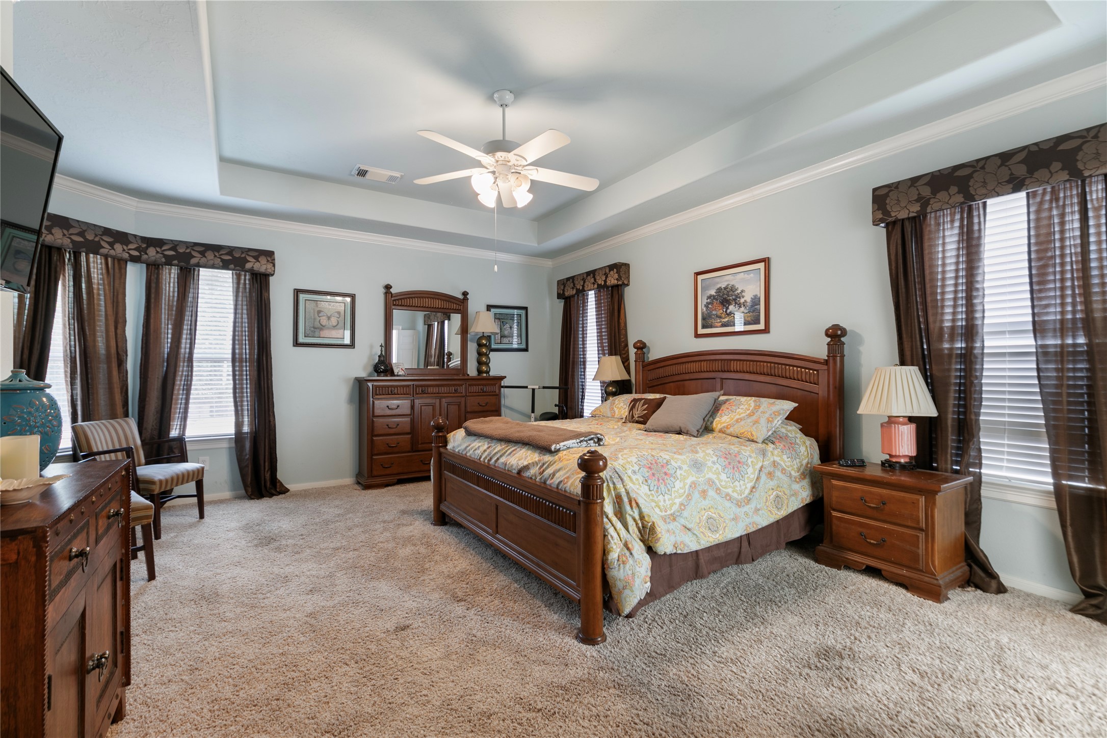 6611 Knollbridge Lane Spring, TX 77379 - Photo 15 of 40 a bedroom with a large bed and a chandelier
