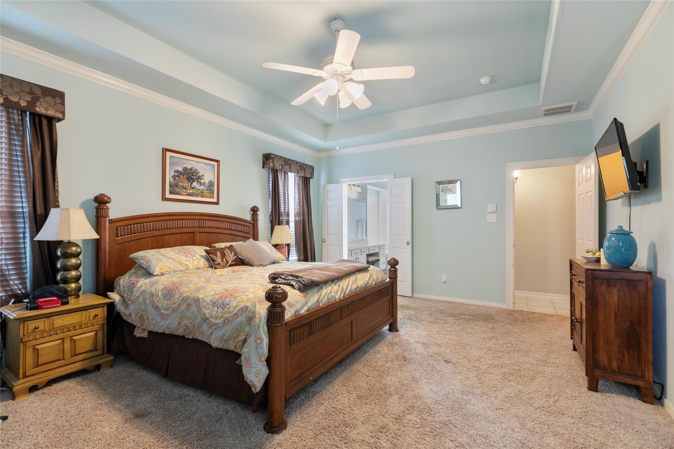 6611 Knollbridge Lane Spring, TX 77379 - Photo 17 of 40 a spacious bedroom with a bed and a chandelier