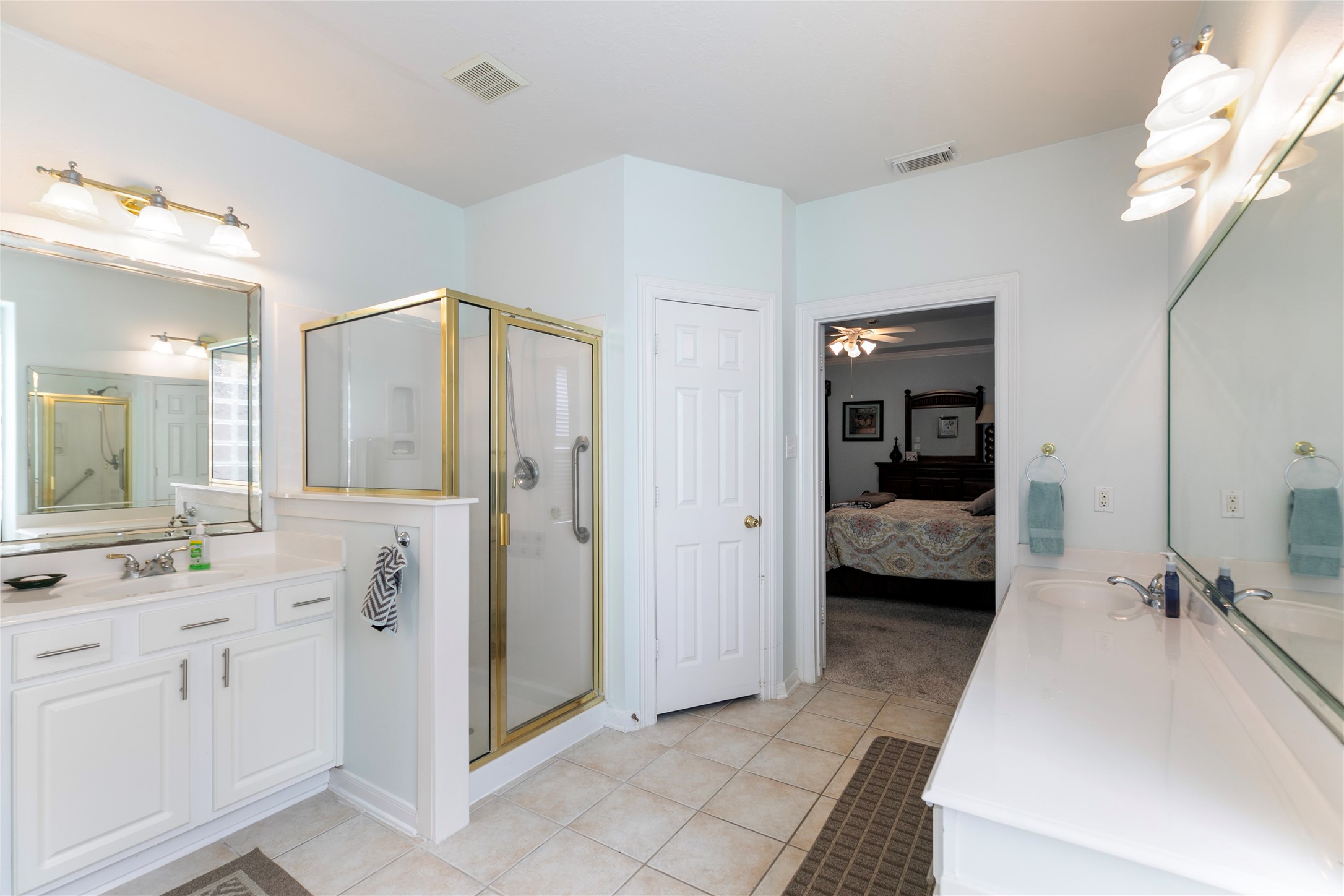 6611 Knollbridge Lane Spring, TX 77379 - Photo 20 of 40 a en suite bathroom with a double vanity sink a mirror and shower