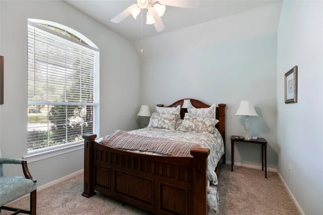 a bed sitting in a bedroom next to a window