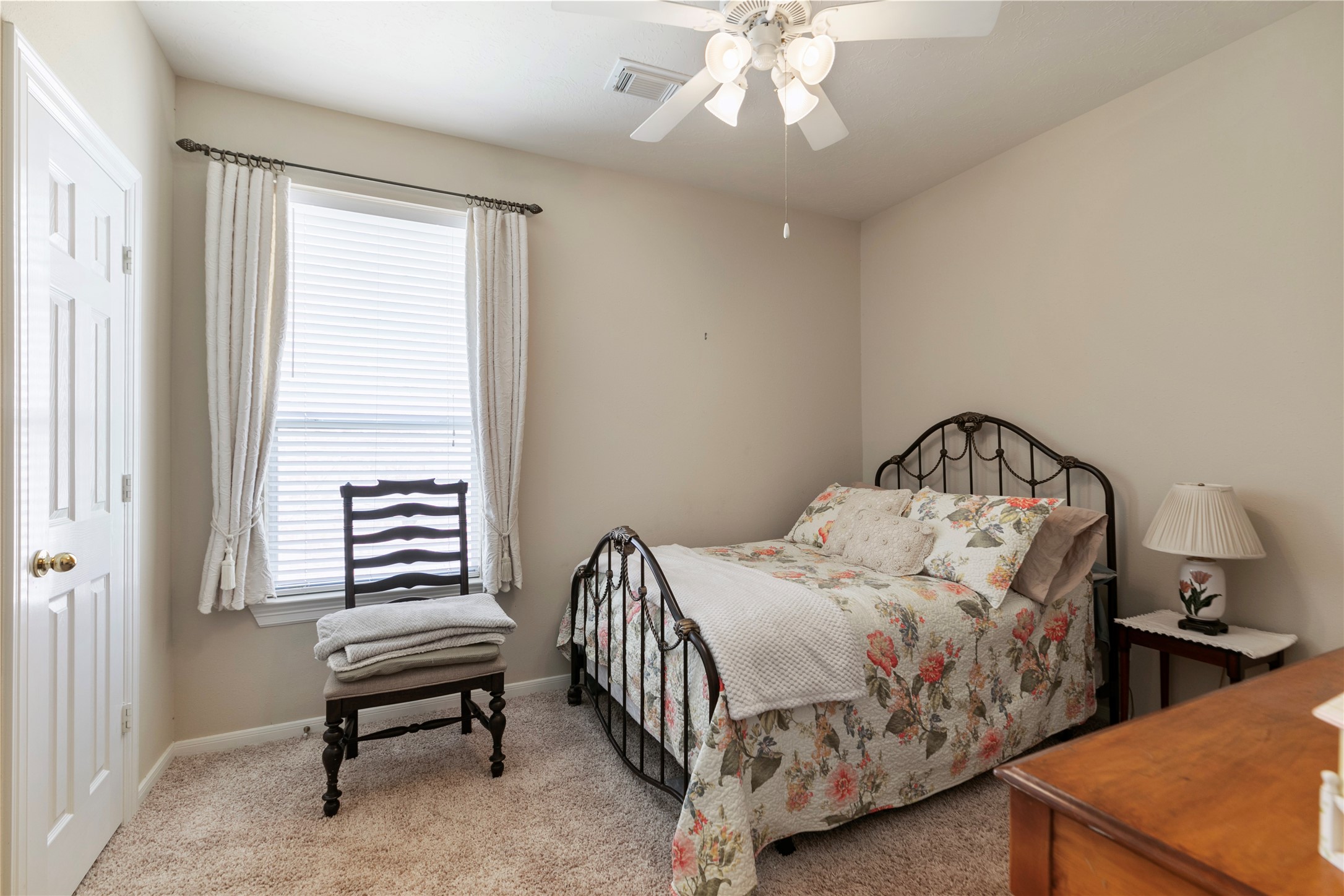 6611 Knollbridge Lane Spring, TX 77379 - Photo 24 of 40 a bedroom with a bed and a chandelier