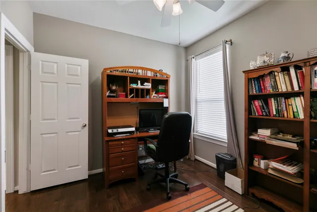 a view of a workspace with furniture and a book shelf