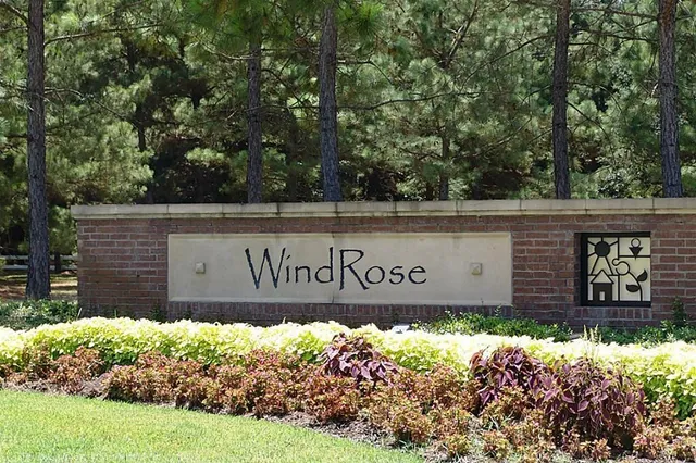 a sign broad in front of a white house