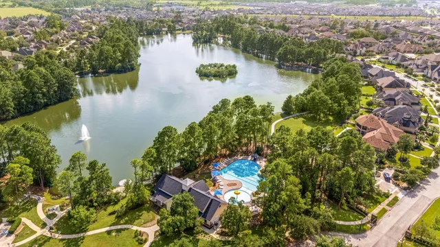 an aerial view of lake residential house with outdoor space and trees around