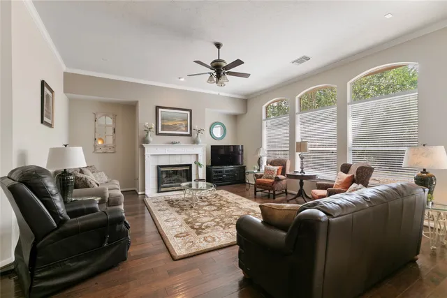 a living room with furniture fireplace and a large window