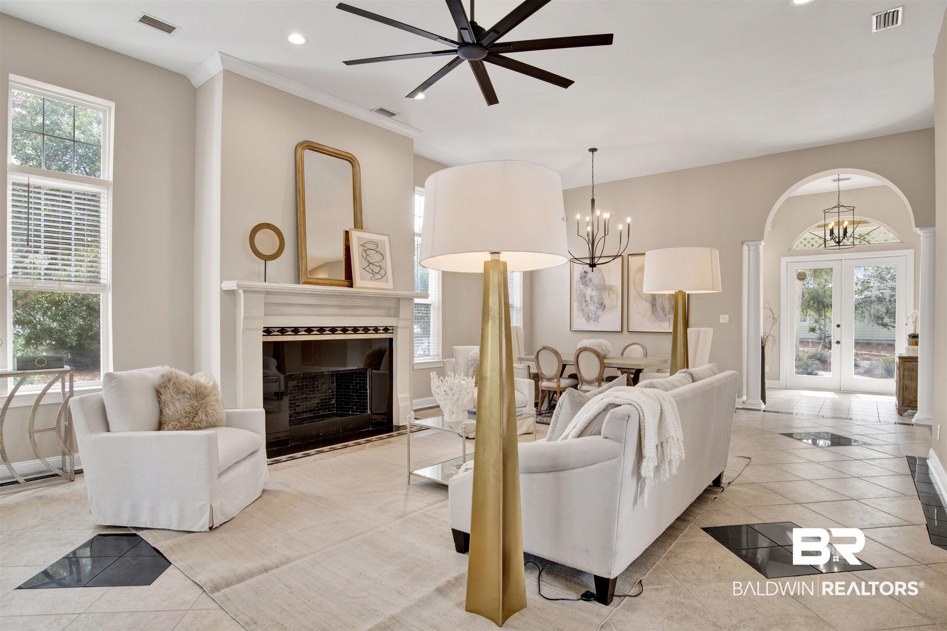 9259 Genipa Way Gulf Shores, AL 36542 - Photo 25 of 72 Living room featuring light tile patterned flooring, ornamental molding, a chandelier, and french doors