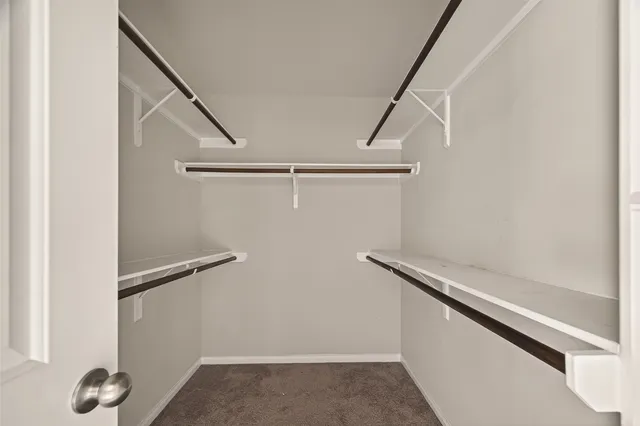 a view of closet with wooden floor