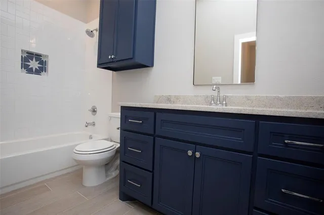 a bathroom with a toilet a sink and bathtub