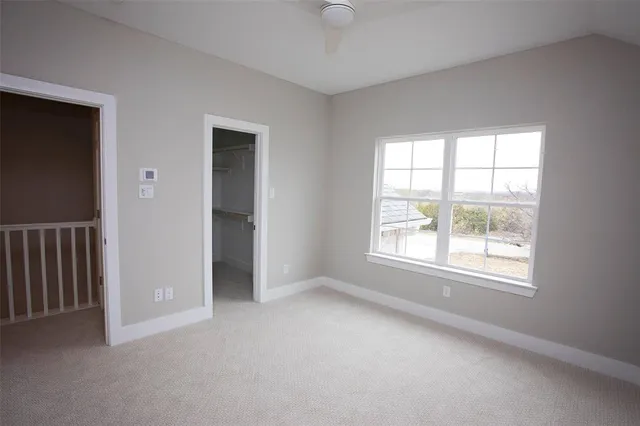an empty room with windows and closet