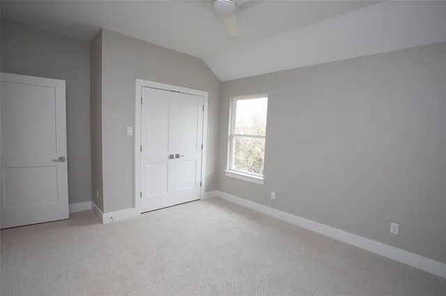 an empty room with windows and closet
