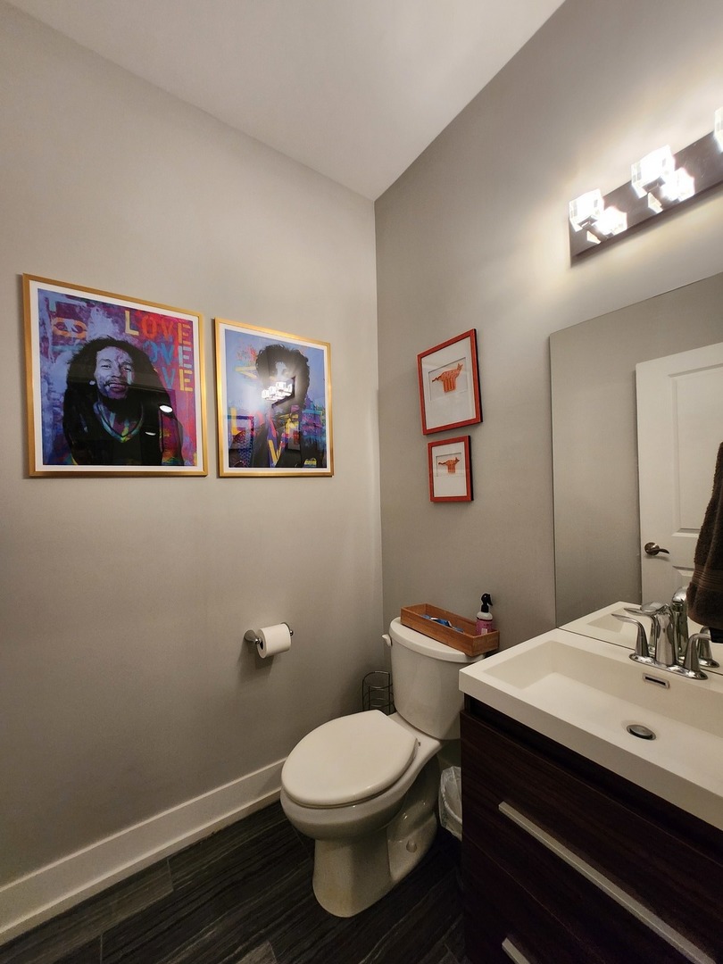 1202 Waukegan Road, Unit 209 Glenview, IL 60025 - Photo 19 of 22 a bathroom with a toilet a sink and mirror
