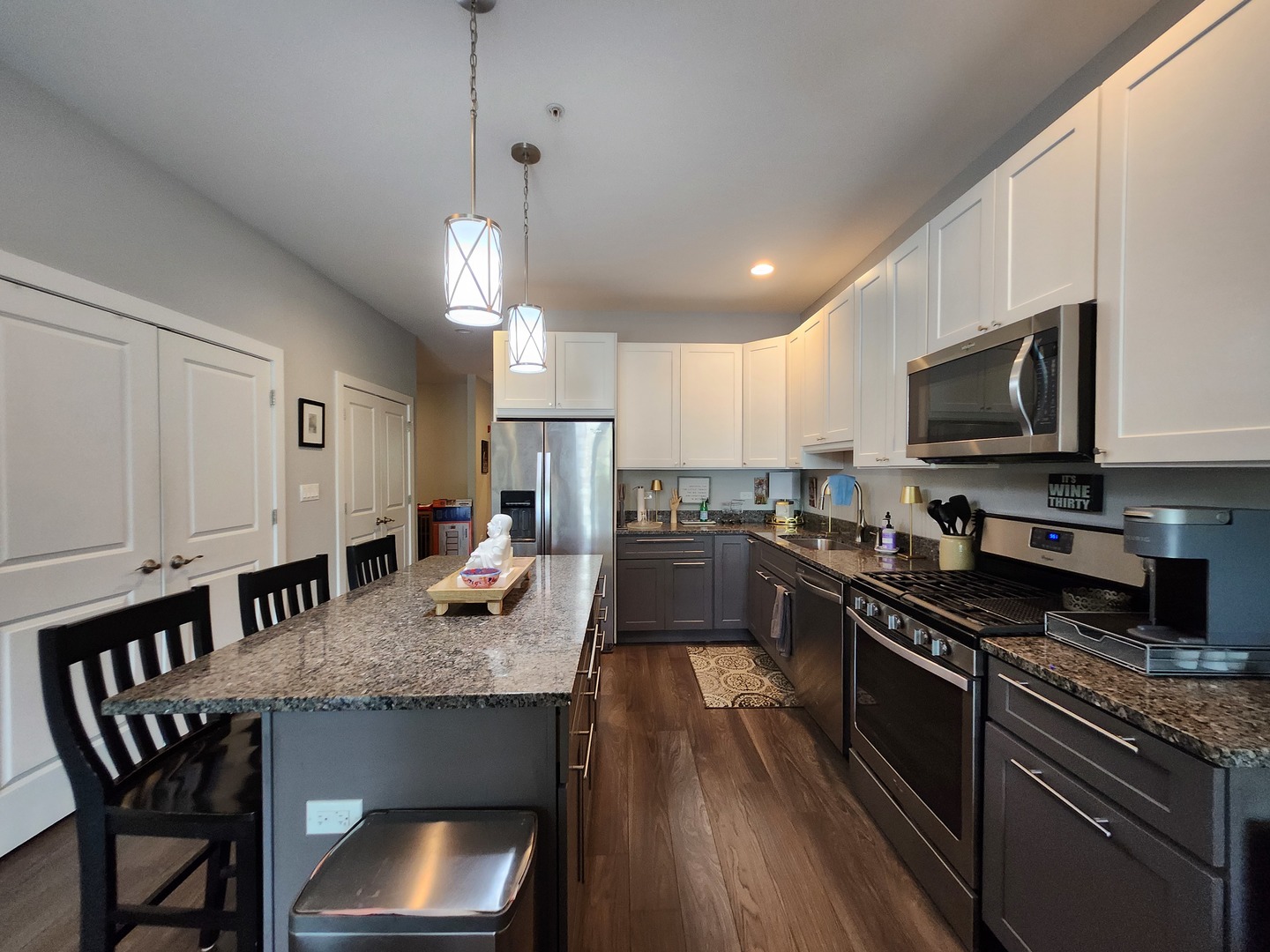1202 Waukegan Road, Unit 209 Glenview, IL 60025 - Photo 4 of 22 a kitchen with granite countertop stainless steel appliances a stove sink microwave and cabinets