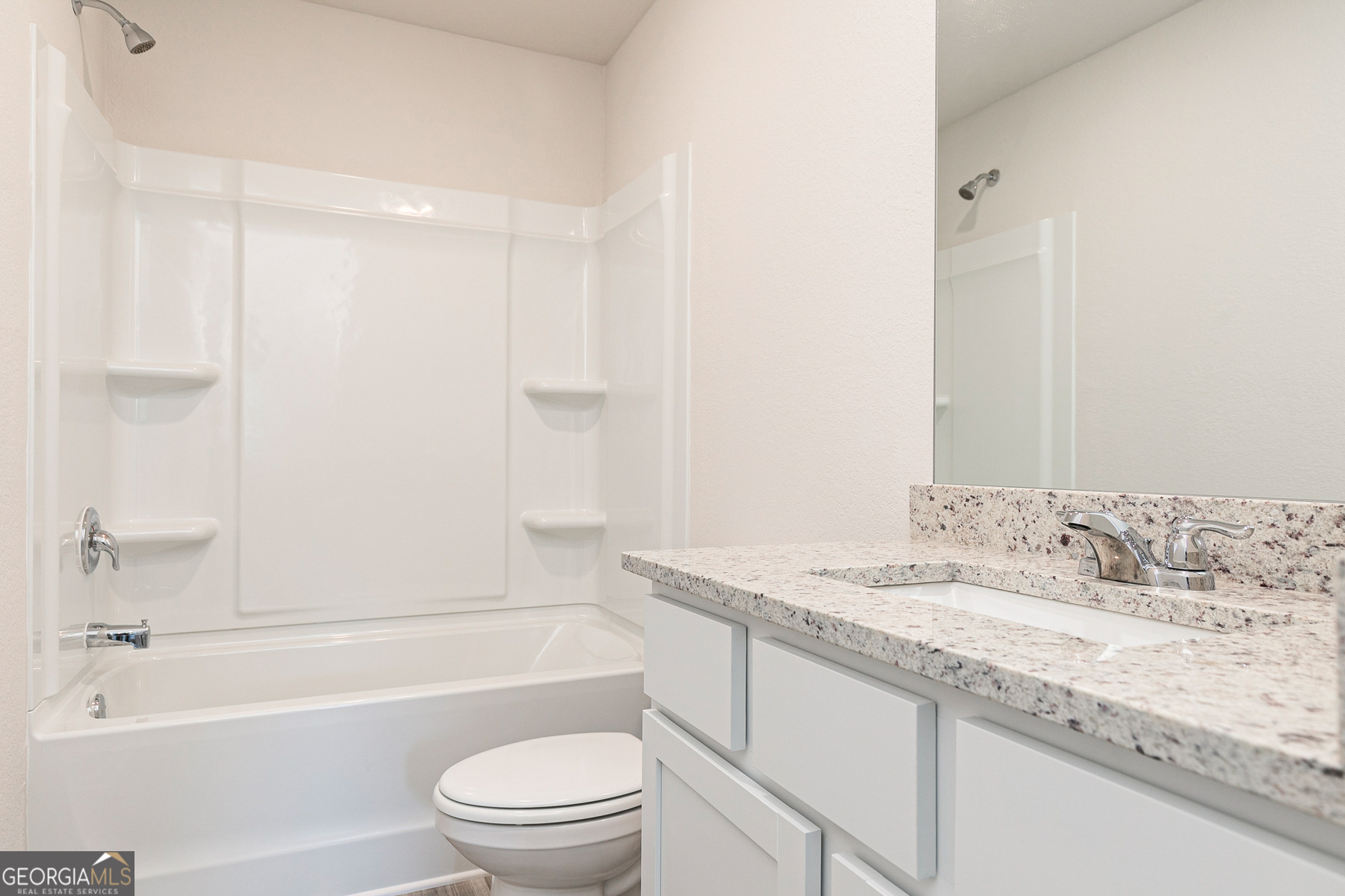 514 Plant Road Conyers, GA 30013 - Photo 13 of 18 a bathroom with a granite countertop sink a toilet and bathtub