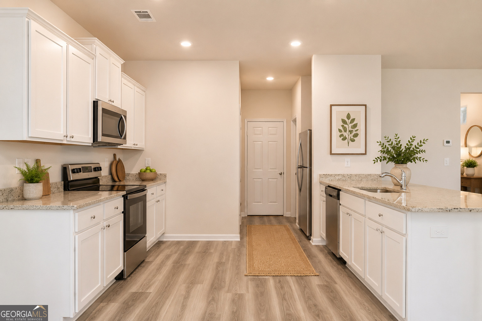 514 Plant Road Conyers, GA 30013 - Photo 14 of 18 a kitchen with stainless steel appliances granite countertop a stove a sink and a refrigerator