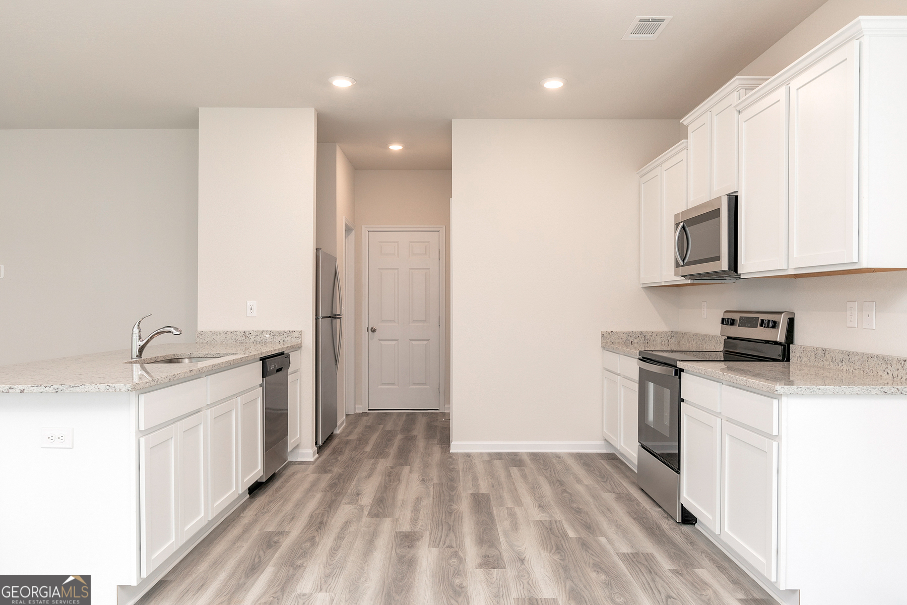 514 Plant Road Conyers, GA 30013 - Photo 6 of 18 a kitchen with stainless steel appliances granite countertop a stove a sink and a refrigerator