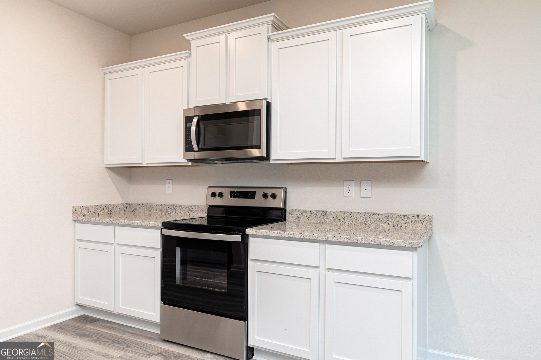 514 Plant Road Conyers, GA 30013 - Photo 7 of 18 a kitchen with stainless steel appliances granite countertop white cabinets and a stove top oven