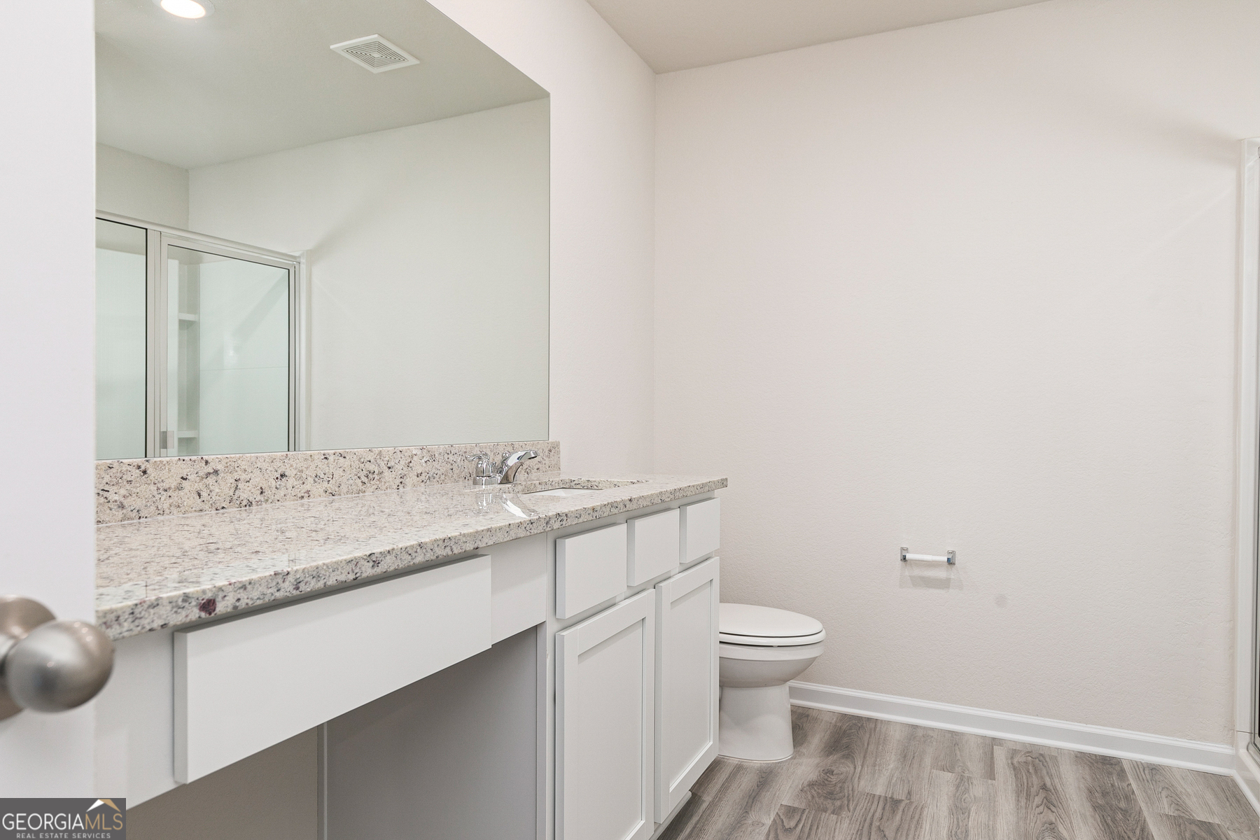 514 Plant Road Conyers, GA 30013 - Photo 10 of 18 a bathroom with a granite countertop sink a toilet and a mirror