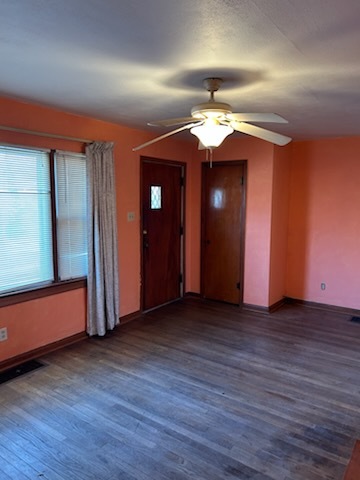 106 South Springer Street Carbondale, IL 62901 - Photo 11 of 20 an empty room with wooden floor and windows