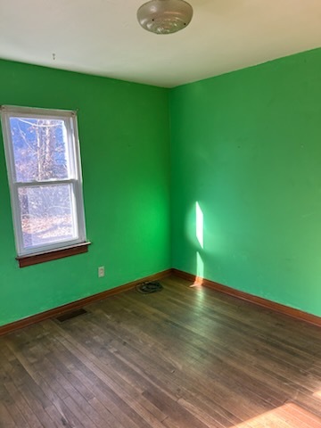 106 South Springer Street Carbondale, IL 62901 - Photo 14 of 20 a view of an empty room with wooden floor and window