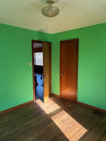 106 South Springer Street Carbondale, IL 62901 - Photo 16 of 20 a view of an empty room with wooden floor and a ceiling fan