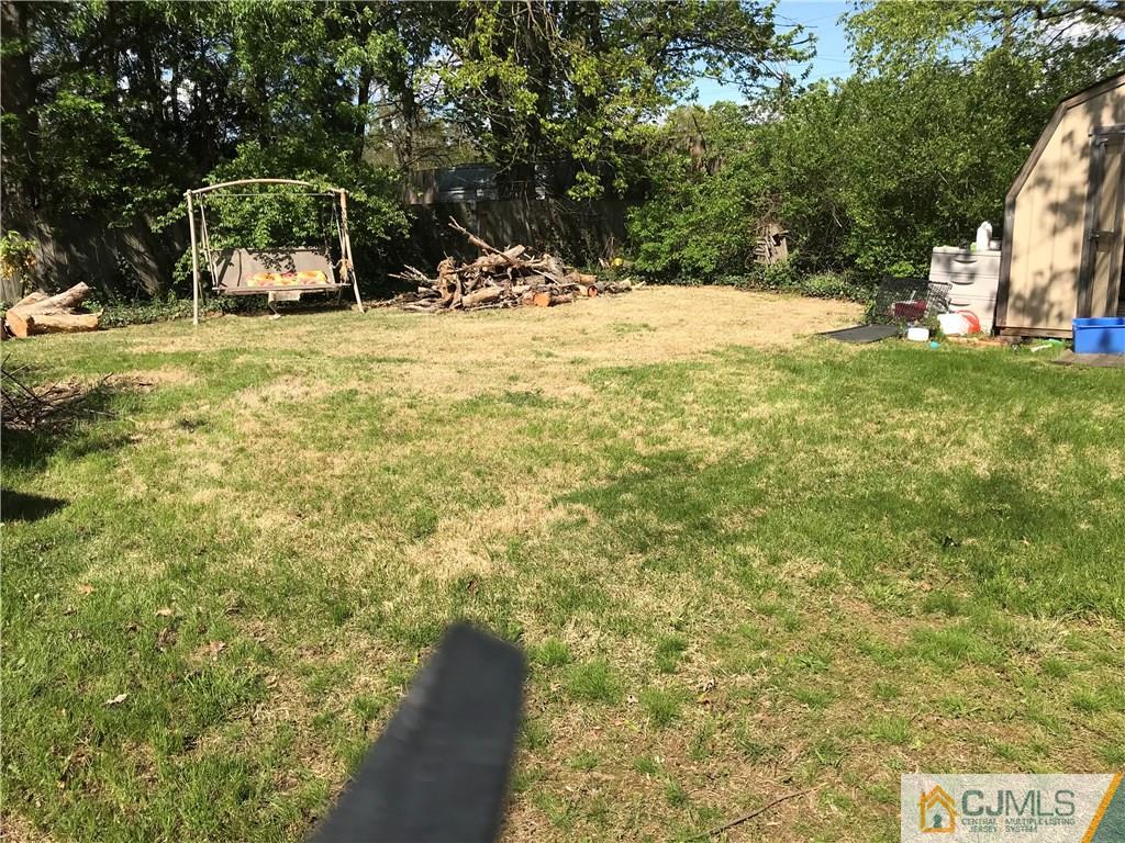 1 Wilshire Road Edison, NJ 08817 - Photo 3 of 3 a view of a yard with yellow house