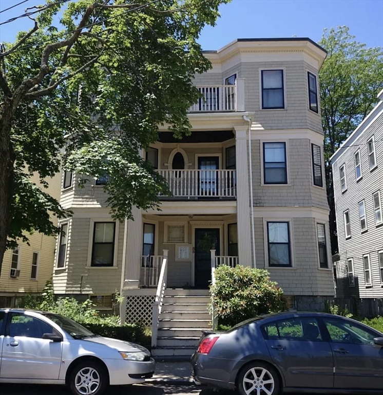 53 Mt Ida Road, Unit 1 Boston, MA 02122 - Photo 1 of 10 a front view of a house with car parked