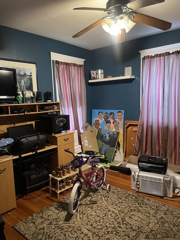 53 Mt Ida Road, Unit 1 Boston, MA 02122 - Photo 5 of 10 a room with furniture a flat screen tv and a window