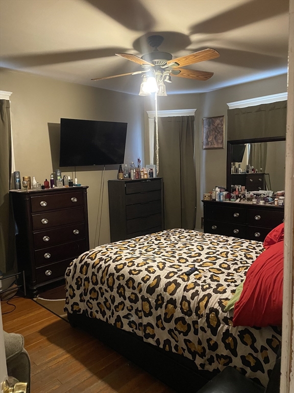 53 Mt Ida Road, Unit 1 Boston, MA 02122 - Photo 7 of 10 a bedroom with a bed and a flat screen tv